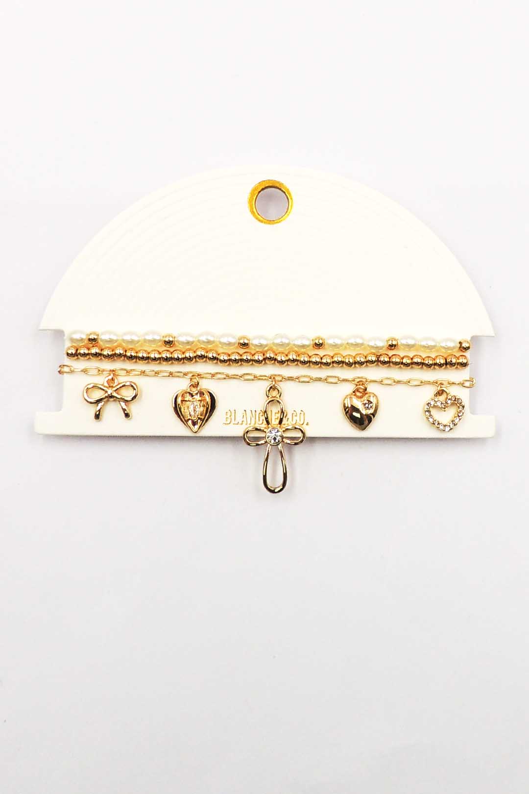 Set of Three Gold and Pearl Stretch Bracelets with Bow, Heart, and Cross Charms