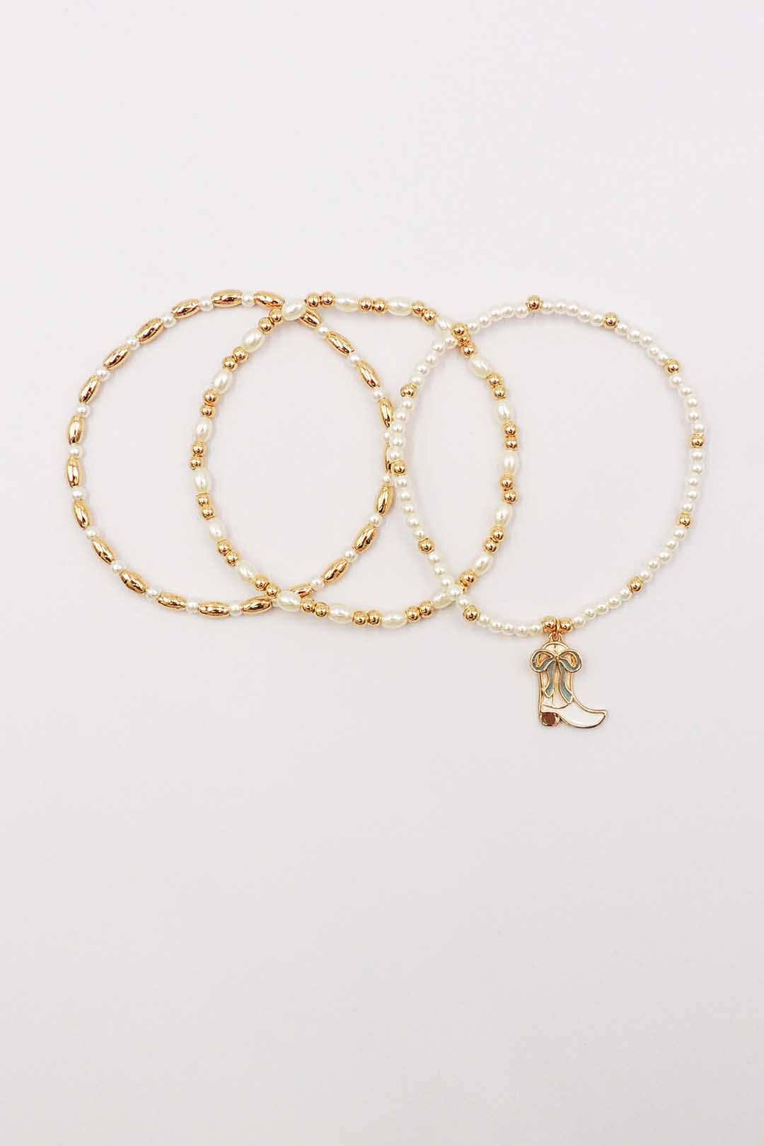 Set of Three Gold and Pearl Stretch Bracelets with Light Blue Bow on White Cowboy Boot Charm
